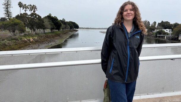 Savannah Stallings, with the San Diego Bird Alliance, stands on a bridge spanning Rose Creek as it flows into Mission Bay in San Diego. Dec. 31, 2025