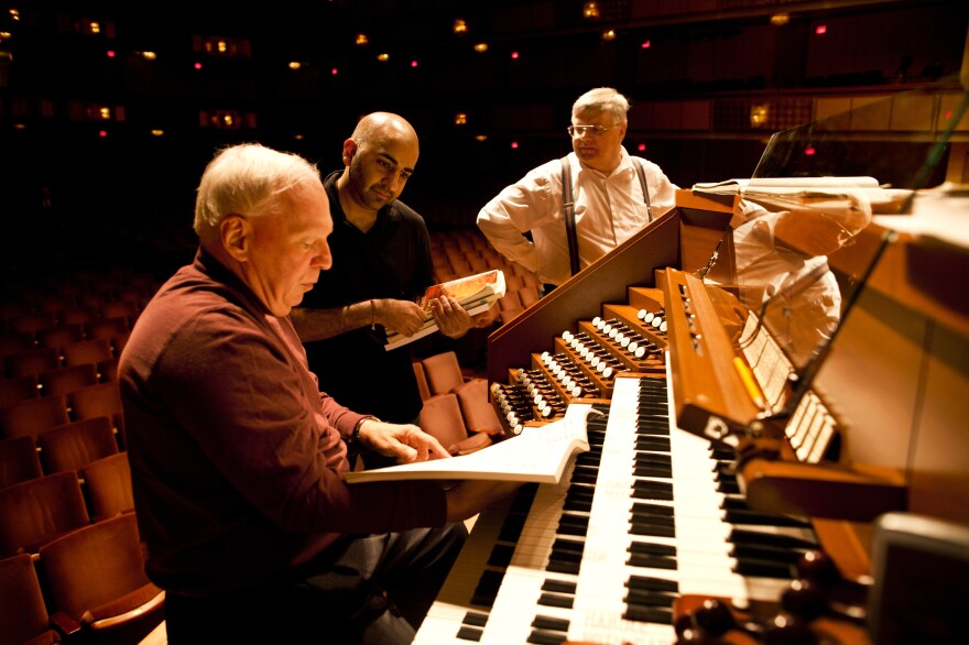 After years of waiting, the Kennedy Center has a new symphonic organ replacing its old organ installed in 1972. The $2 million project will culminate in the organ's debut on Nov. 27. William Neil (left), the National Symphony Orchestra organist, speaks with NSO Assistant Conductor Ankush Kumar Bahl (center) during the organ's test with the orchestra on Oct. 18.