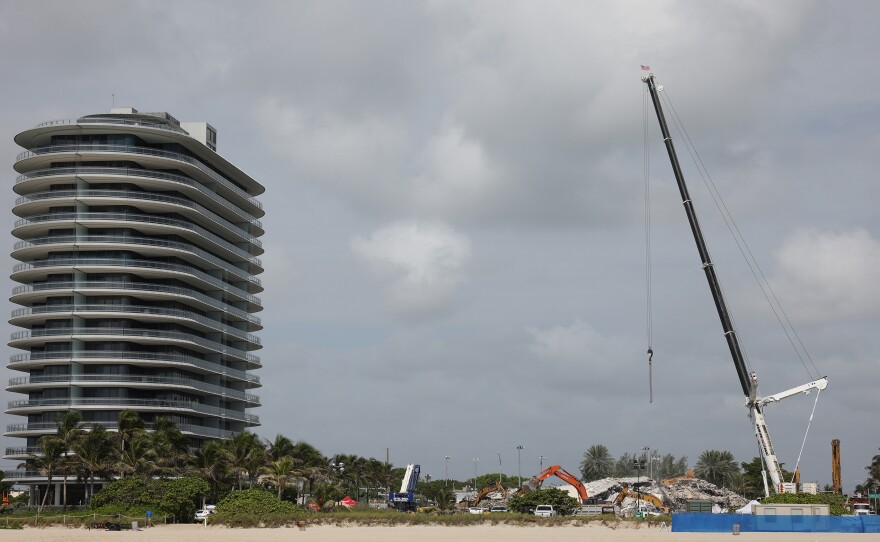 Cranes are operated over the remains from the collapsed 12-story Champlain Towers South condo building on July 9, 2021 in Surfside, Fla.