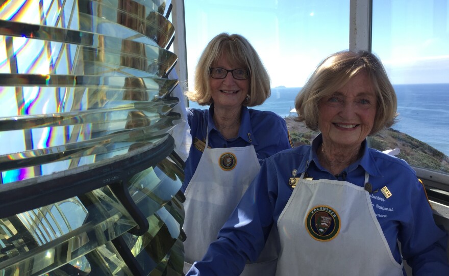 Twin sisters Kim Fahlen (left) and Karen Scanlon clean the Fresnel lens in the tower of the Old Point Loma Lighthouse, Nov. 2, 2017.
