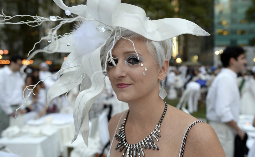 Many guests see Diner en Blanc as an occasion to unleash their fashion whimsy. The event is always held outdoors, always at a landmark location revealed at the last-minute. Here, a guest at the Bryant Park event last week.