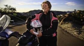 Nancy Fuller beams with joy after a ride on her motorcycle in Alpine.