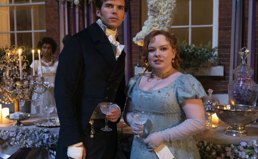 Luke Newton as Colin Bridgerton and Nicola Coughlan as Penelope Featherington.