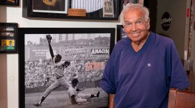 Bobby Richardson at J.O’Grady’s restaurant in downtown Sumter, SC, which displays hundreds of Sumter sports artifacts. Here, Richardson stands next to a framed photo of him sliding into first base in front of San Francisco Giant Willie McCovey.