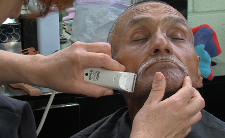 Antonio de la Peña Hernandez, a deportee, gets a shave at a Tijuana migrant shelter called Desayunador Salesiano Padre Chava.