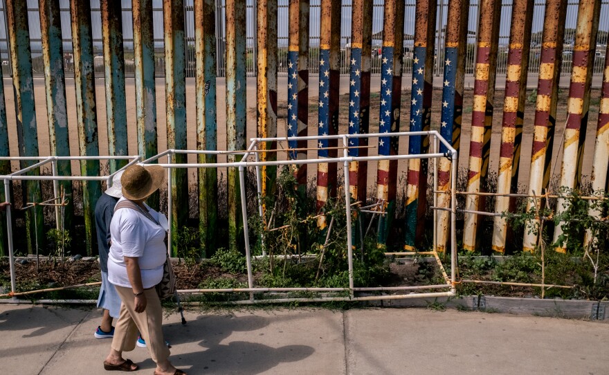 Border wall fence woman