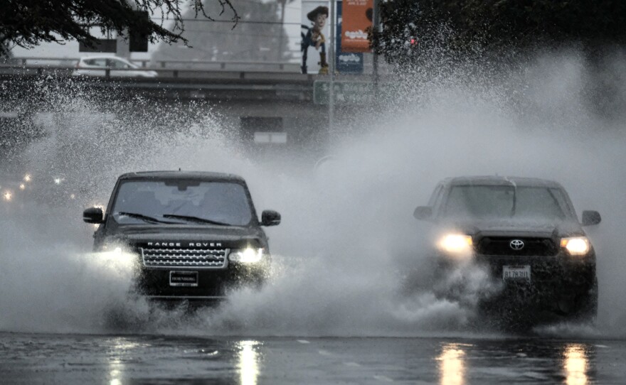 A flooded street in the Van Nuys section of Los Angeles on Sunday. Some California residents evacuated neighborhoods below hillsides scarred by wildfires, amid concerns about mudslides.