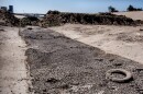 An earthen berm made up of dirt and debris blocks the flow of waster from Mexico into the United States in the Tijuana River, June 14, 2022.