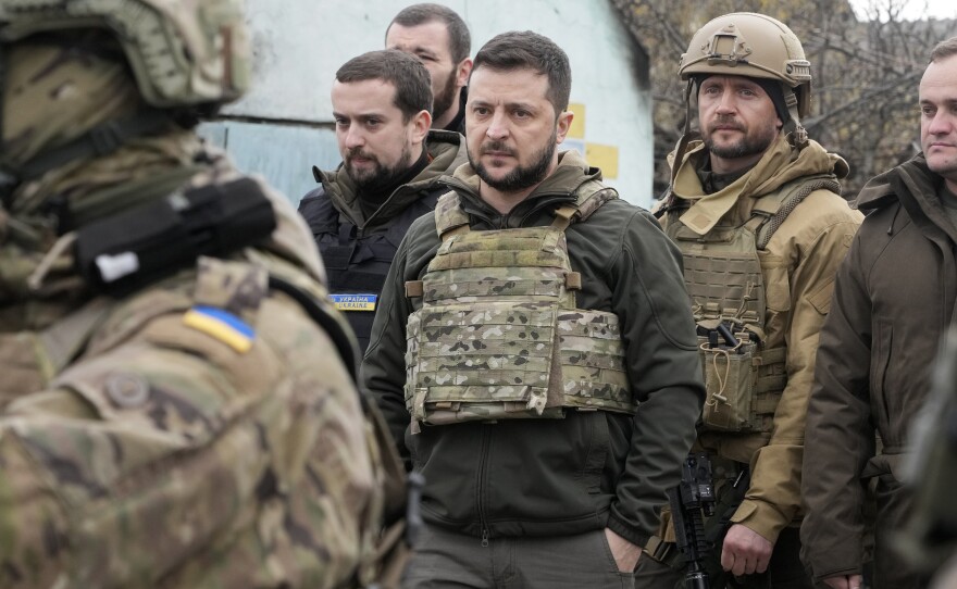 Ukrainian President Volodymyr Zelenskyy examines the site of a recent battle in Bucha on Monday. Russia is facing a fresh wave of condemnation after evidence emerged of what appeared to be deliberate killings of civilians in Ukraine.