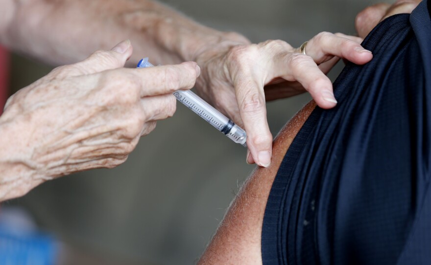 A man receives a COVID-19 vaccine at a clinic in Springfield, Mo., in June. Vaccination rates in southern Missouri are low, a factor officials say is helping drive what's now the nation's largest outbreak.