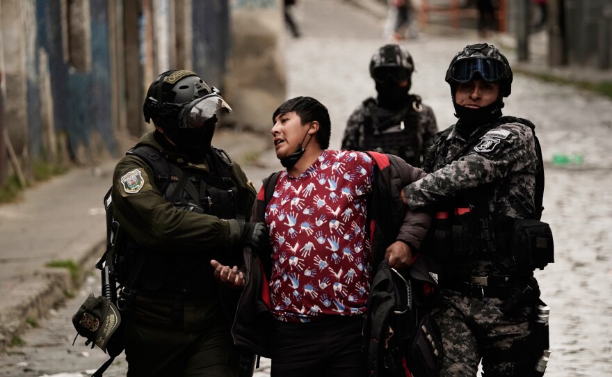 Police officers detain a demonstrator during an anti-government protest in La Paz, Bolivia, Monday, May 18, 2026.