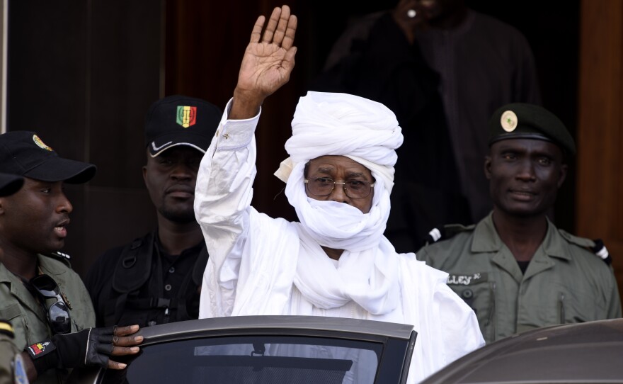 Hissene Habre, the former president of Chad, waves as he leaves a courthouse in Dakar, Senegal, on June 3. Habre was ousted from Chad in 1990 and has lived in exile in Senegal ever since.