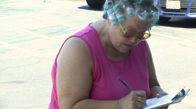 A woman who said she heard on the radio from The Mike Slater Show that the petition drive to overturn the minimum wage increase was nearing its end rushed to Albertsons in Allied Gardens on Thursday, Sept. 11, 2014 to sign. 