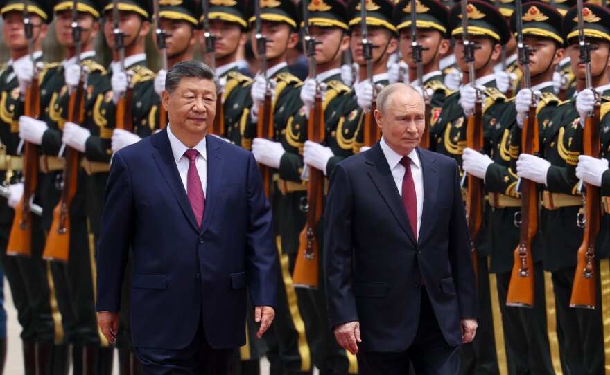 Russian President Vladimir Putin, right, and Chinese President Xi Jinping inspect an honor guard during a welcoming ceremony at the Great Hall of the People in Beijing Wednesday, May 20, 2026.