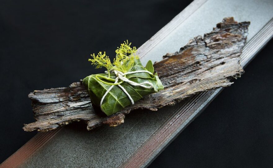 Greens served on a plate made of bark at N/Naka.