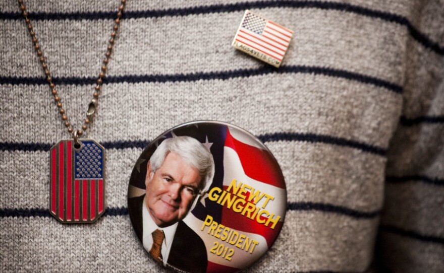 A Gingrich supporter shows off a campaign button at a town hall meeting in New York.