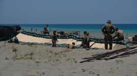 Soldiers of the U.S. Army's 25th Infantry Division build fighting positions along the beach of the La Paz sand dunes in Laoag City, Philippines, ahead of counterlanding exercises during annual Balikatan drills.