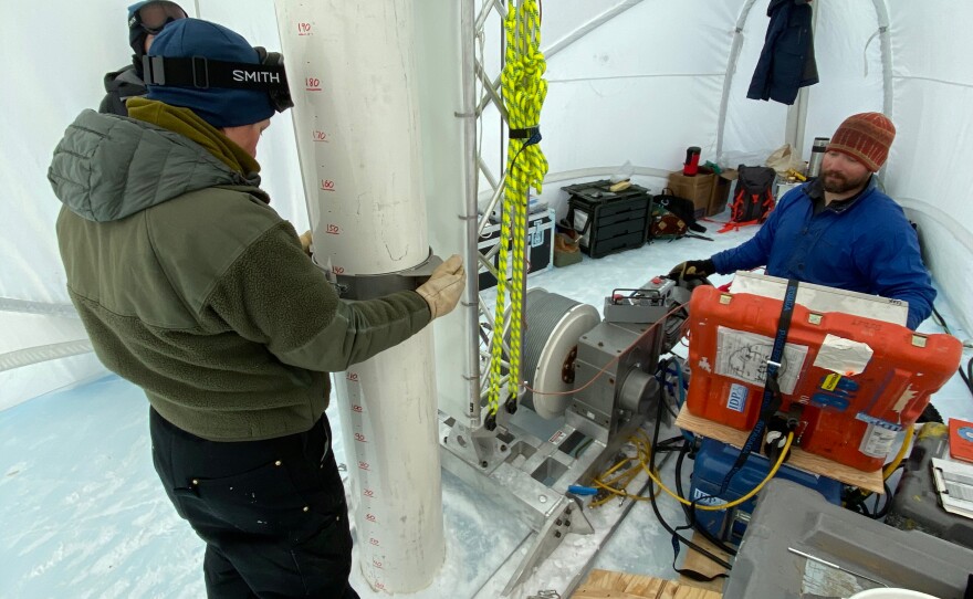 Graduate student Jenna Epifanio keeps the drill barrel straight while driller Tanner Kuhl lowers it into the hole in 2019. This Antarctica expedition focused on recovering large volume samples of the 2-plus-million-year-old ice discovered four years earlier.
