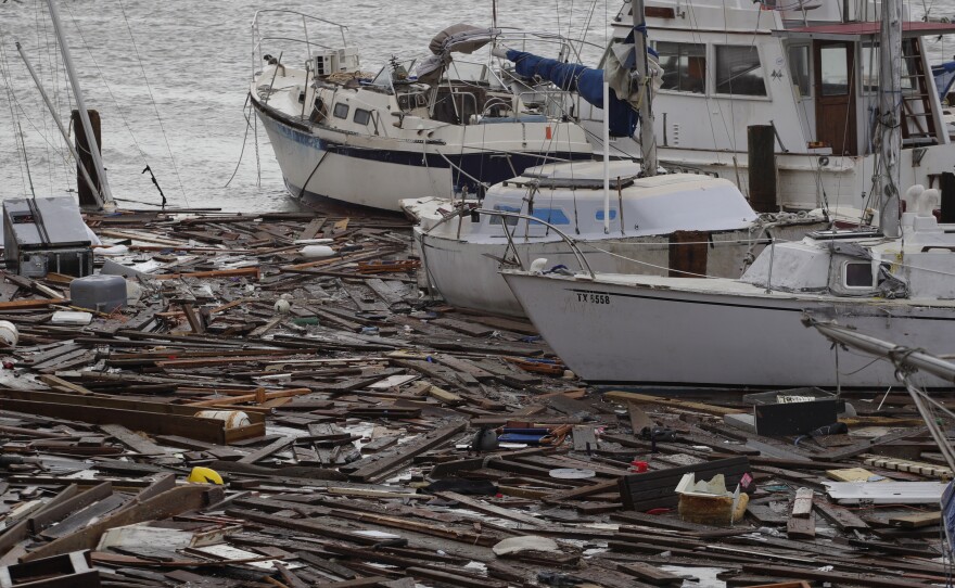 Broken boats and floating debris at a marina in Corpus Christi are among the damage caused by Hurricane Hanna, which was downgraded to a tropical storm and continued to shower Texas with heavy rain on Sunday.