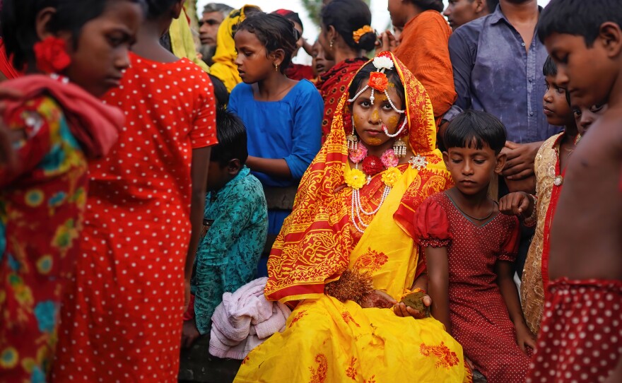 A 14 year old school girl Hafsa sits with friends and neighbors while posing for photos on her wedding day at a village named Joymoni from a coastal area from Mongla in Bagerhat district. Bangladesh witnessed a 13% increase in child marriages during the Covid-19 pandemic last year as the deadly virus massively affected societies and economies, pushing many into extreme poverty.