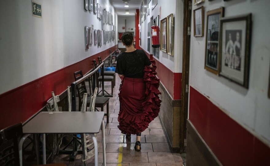 A student walks down the hallways at Amor de Dios, full of history.