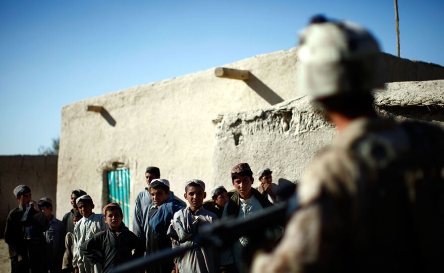 Marines talk with villagers while on patrol outside Patrol Base Hassan Abad in Helmand province.