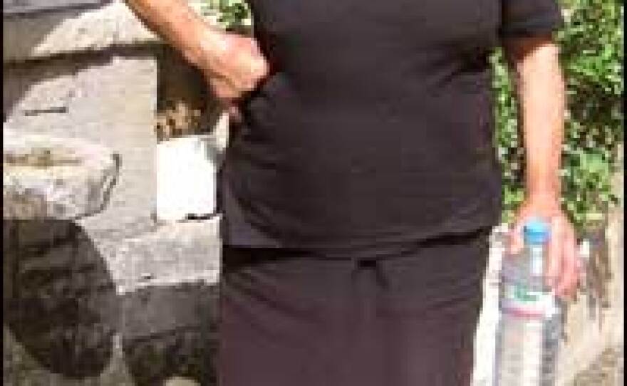 Antigone Skoula gets water from the village well. Extreme heat has caused water shortages in the town of Agia Varvara.