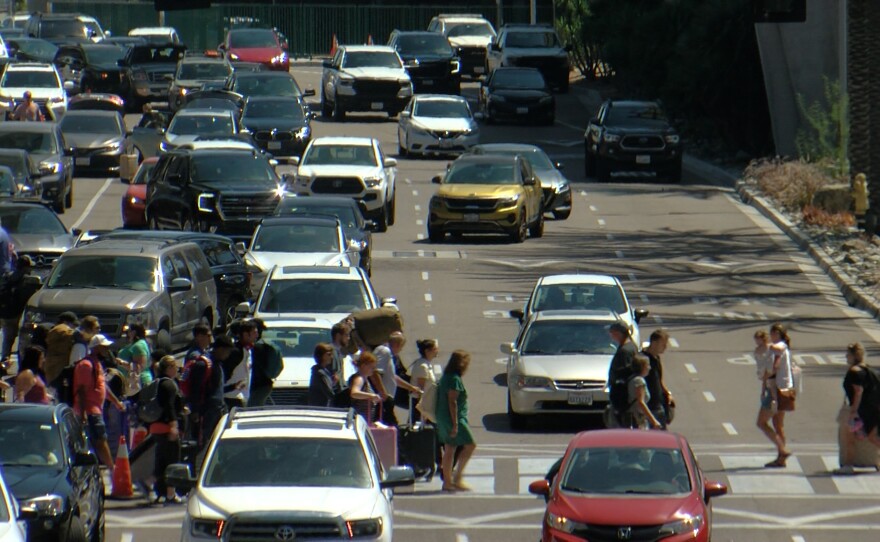 People and cars at the pickup area for arriving passengers at San Diego International Airport on September 2, 2022.