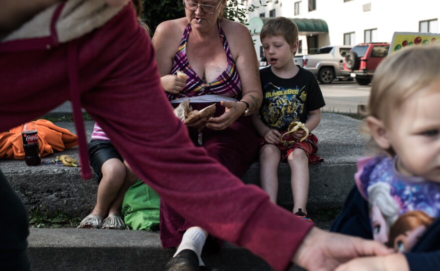 Teresa Baker sits with her grandchildren, James Rose, 4, and Adeline Steele, 18 months, whom she cares for. She says she doesn't vote. "I don't have time for that," she said.