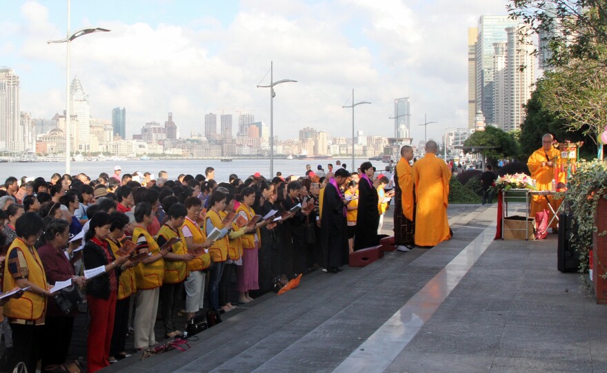Hundreds of Buddhists gather along the banks of Shanghai's Huangpu River to sing and release fish and mollusks in an ancient Chinese ritual. Fishermen wait downstream and scoops them up almost immediately.