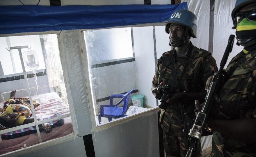 United Nations peacekeepers stand next to a patient during a visit of the U.N. secretary-general at an Ebola treatment center in Mangina, North Kivu province, last September.