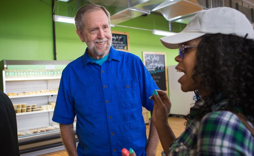 Daily Table founder Doug Rauch greets customer Latoya Rush after she walks into the store.