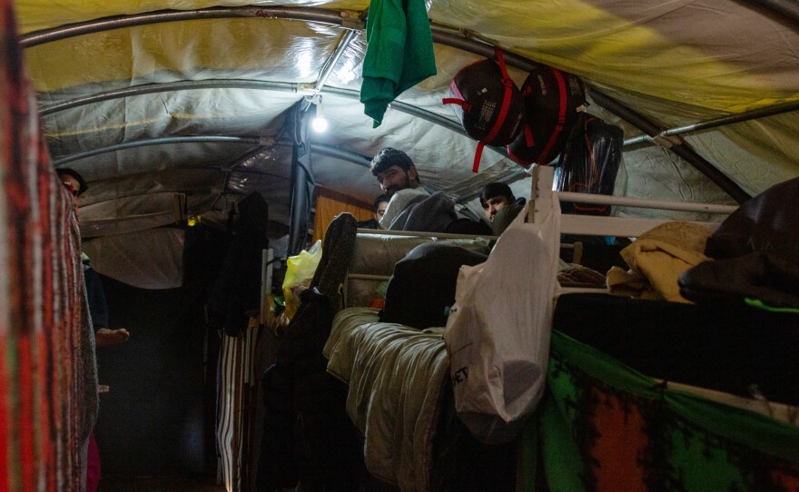 Pakistani Mohammed Arsal (left), 29, is one of 800 people living in Bosnia's new Lipa camp, which has been under reconstruction since a fire gutted it last December. He says he has been stopped, pushed back and beaten up five times during his crossing attempts.