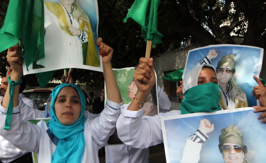 Supporters of Libyan leader Moammer Gadhafi protest outside U.N. offices in Tripoli on Saturday.