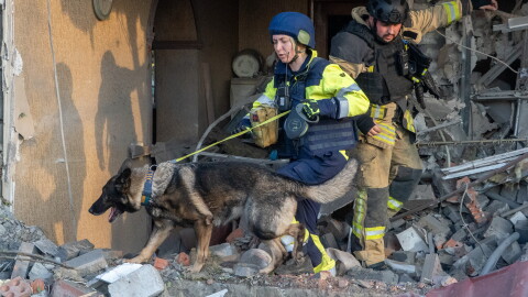 Rescuers with a search dog look for victims among the rubble of a house after a Russian air attack in Kharkiv, Ukraine, Tuesday, Oct. 20, 2026.