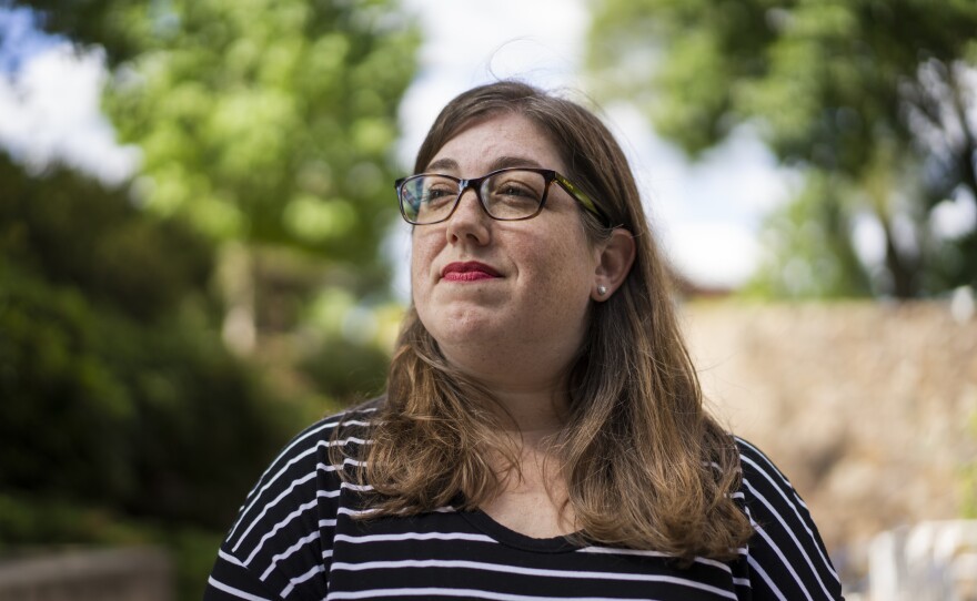 Kristin Zawatski, a training project manager, stands outside the Feldberg Communications building at Brandeis University in Waltham, Mass., on June 28.