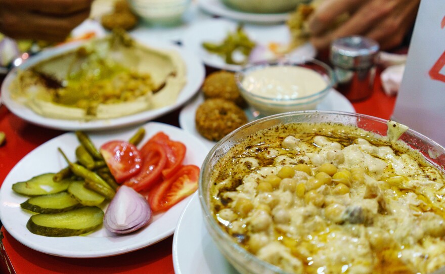 Plates piled with traditional Syrian food cover the table at Orijinal Halep Lokantasi, a restaurant in the southern Turkish city of Gaziantep.