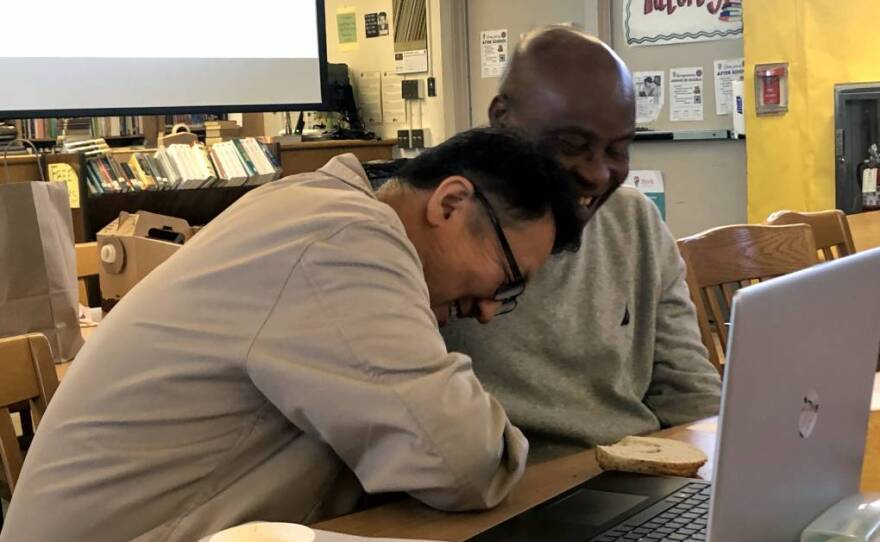 During a meeting of the Compton Male Teachers of Color Network, Dominguez High School teachers Chung Mo Kim and Chikodi Ojini share a laugh while talking about what they learned from visiting one another’s classrooms in this undated photo.