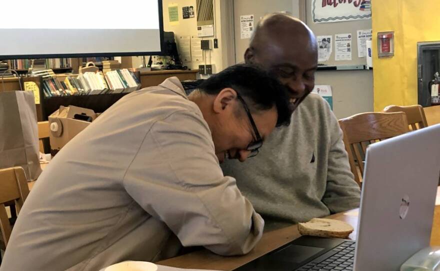 During a meeting of the Compton Male Teachers of Color Network, Dominguez High School teachers Chung Mo Kim and Chikodi Ojini share a laugh while talking about what they learned from visiting one another’s classrooms in this undated photo. 