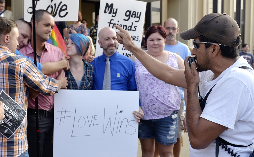 Edgar Orea, right, addresses a group of same-sex marriage supporters outside the Carl D. Perkins Federal Building in Ashland, Ky., Thursday. Rowan County is set to issue marriage licenses to same-sex couples Friday.