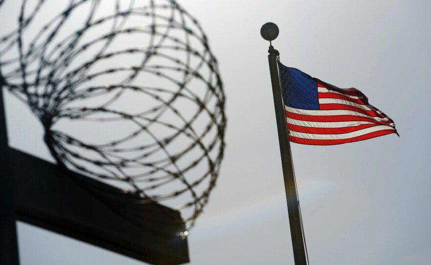 A U.S. flag flies above a fence at the detention facility at the U.S. Naval Station at Guantánamo Bay, Cuba, on Dec. 10, 2008, in an image reviewed by the U.S. military.