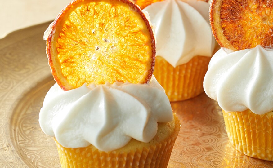 Orange curd cupcakes topped with citrusy orange chips.