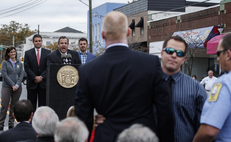 A man is removed by security guards while he shots slogans to New Jersey Governor Chris Christie during a public event in Belmar, N.J.