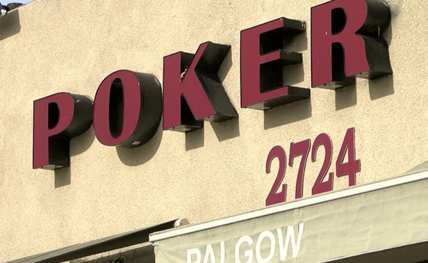 A sign on the Palomar Card Club on El Cajon Boulevard in San Diego touts that it offers poker at the establishment, Dec. 9, 2015.
