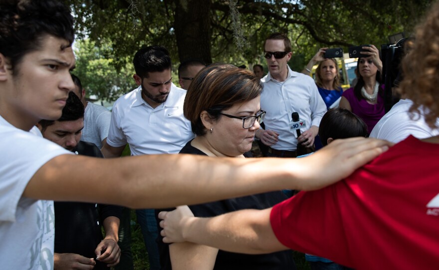 Surrounded by volunteers, family and friends of the victims of the Pulse Nightclub shooting leave the Beardall Senior Center where they gathered to learn more information about loved ones who were injured or killed in the shooting on Sunday.