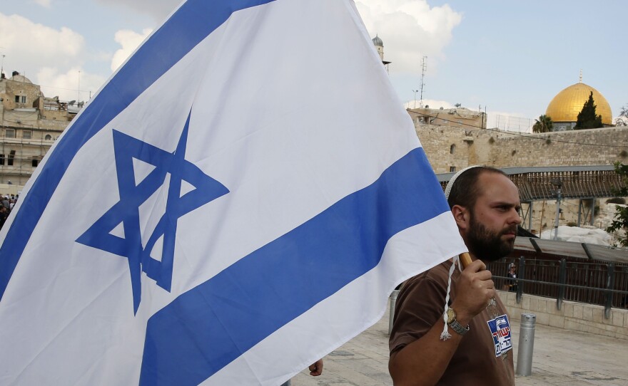 Right-wing Israelis demonstrate Oct. 30 at the Western Wall plaza in Jerusalem, where tensions have been on the rise. In the background is the golden Dome of the Rock, part of the holy site the Muslims call the Noble Sanctuary. The ancient Jewish Temples were also located on the site, which Jews call the Temple Mount.