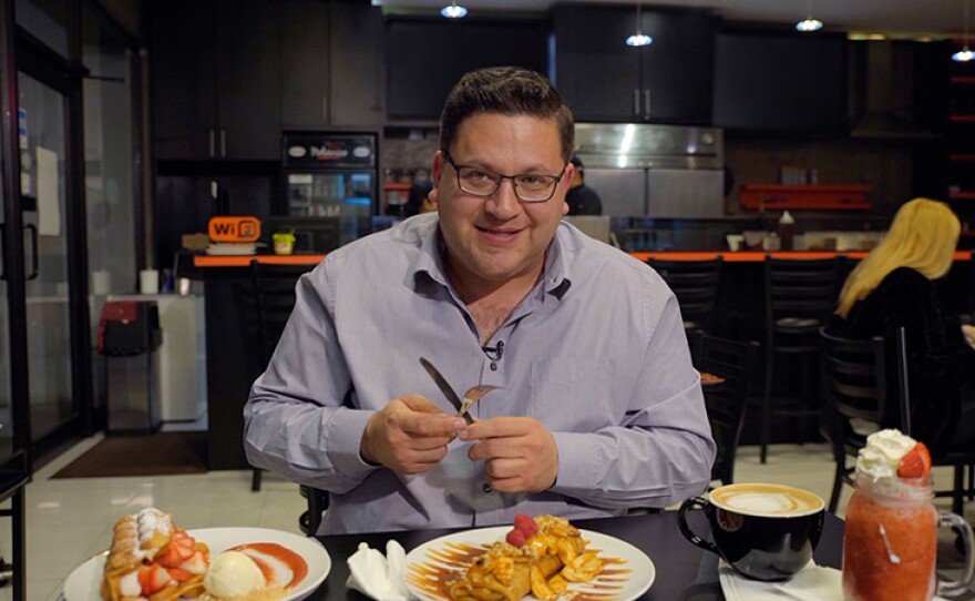 Host Jorge Meraz cuts into a chocolate-nuttela-mousse-banana crepe at Creperia Polanco in Tijuana, Mexico.