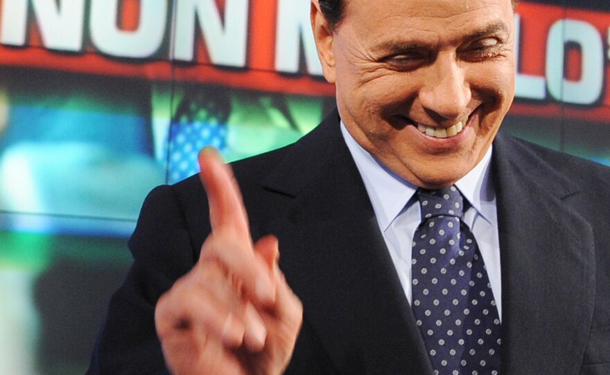 Italian Prime Minister Silvio Berlusconi on the set of the TV talk show <em>Porta a Porta</em> (<em>Door to Door</em>) on Italian channel Rai 1 in Rome as the phrase "I don't give up" is projected behind him on June 3. The 72-year-old billionaire prime minister is currently under fire for a series of allegations concerning his private life.