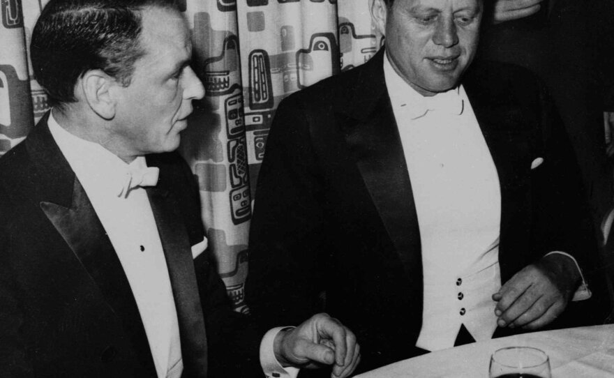 President John F. Kennedy sits with Frank Sinatra at his Inaugural Ball in 1961.