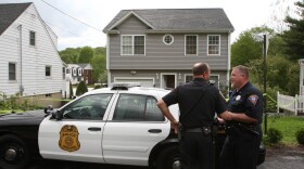Police stand outside a former home, which was forclosed on, owned by Faisal Shahzad is seen May 4, 2010 in Shelton, Connecticut. Faisal Shahzad, 30, a suspect in this past weekend's failed car bomb plot in Times Square was taken into custody late Monday by FBI agents and New York Police Department detectives while trying to leave the country at John F. Kennedy Airport.